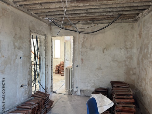 Interior renovation with exposed beams and building materials