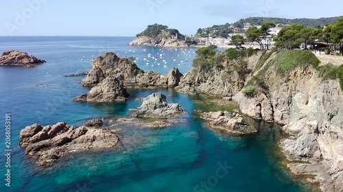 Aerial view of the rugged cliffs surrounding Tossa de Mar, where rocky reefs, hidden coves and crystal-clear Mediterranean waters create a spectacular coastal landscape. 