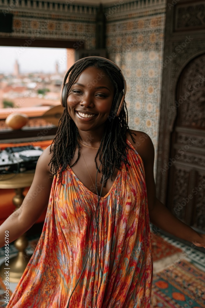 Fototapeta premium Young woman smiling while standing near balcony window interior