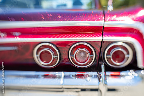 Photos Close-up of triple chrome tail lights on a classic Chevrolet Impala,  November 2025