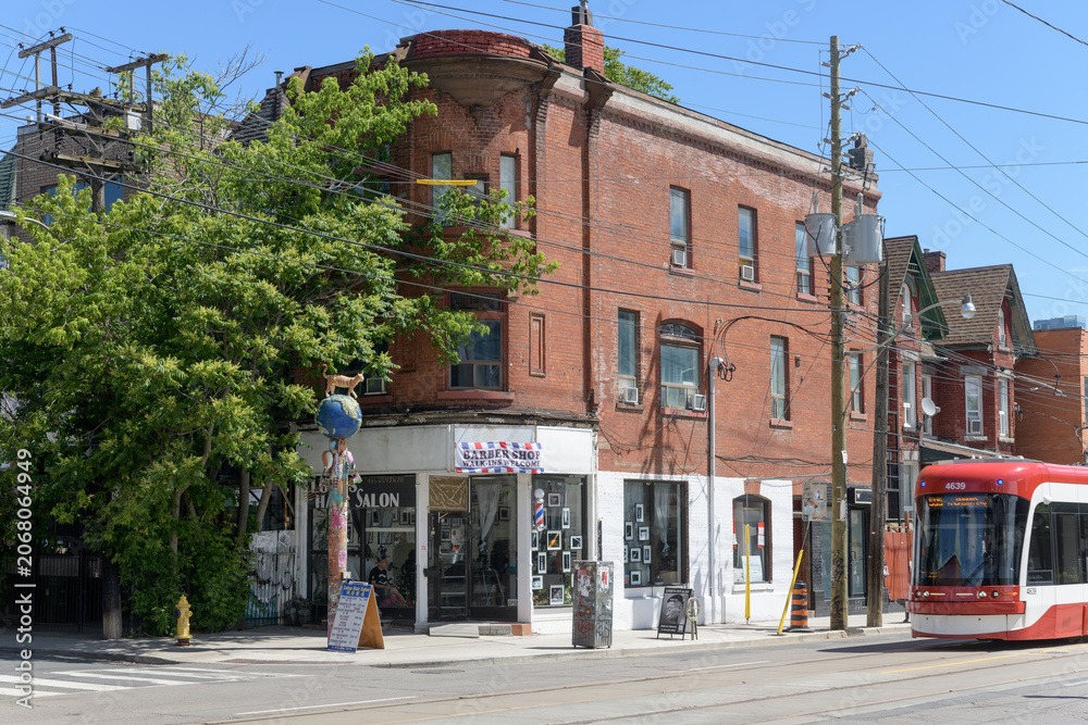 Obraz premium exterior of historic apartment and commercial block at northeast corner of Augusta Av and Dundas W - location of Luke’s barber studio, Toronto