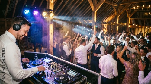 Guests dance and raise their hands as the DJ plays, filling the wedding reception with energy, movement and celebration.