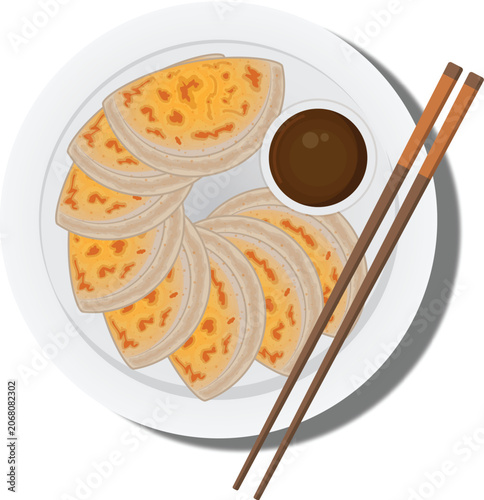 Plate of panfried dumplings with soy sauce