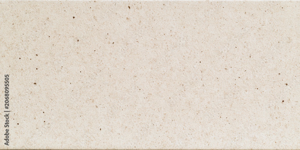 Fototapeta premium Surface made of light-colored stone with small dark specks in a clean and uniform pattern for building projects and design