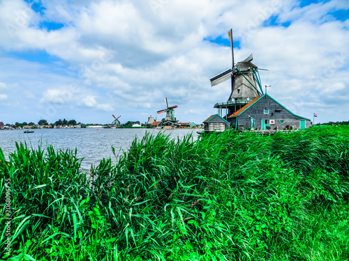 Traditional Dutch old wooden windmills in Zaanse Schans - museum village in Zaandam. The Netherlands.
