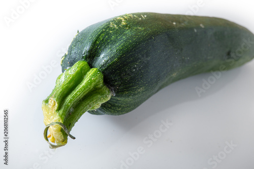 Fresh zucchini on a plain surface showcasing its green color and shape