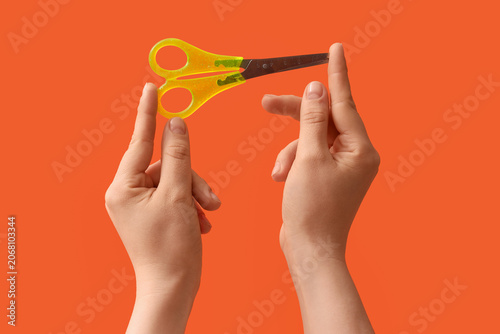 Childs hands holding yellow...
