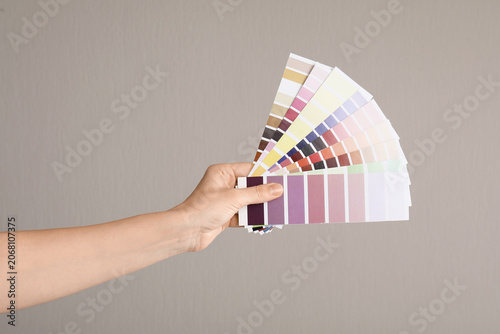 Hand holding color swatch p...