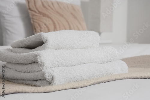 Stack of clean towels on be...