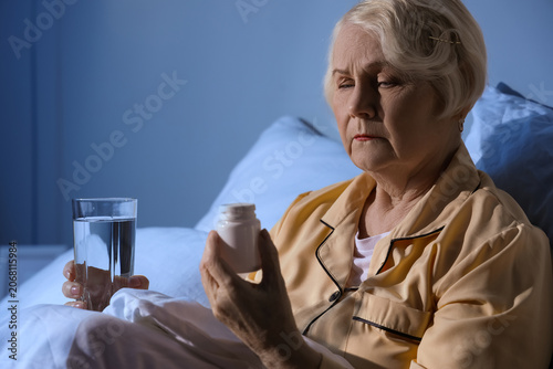 Senior woman with pills fro...