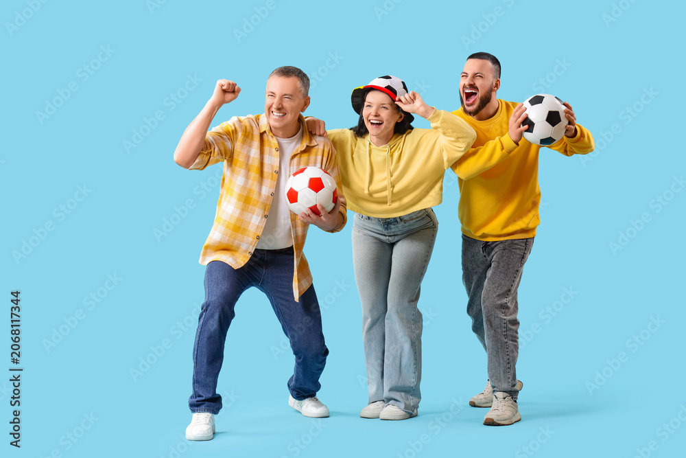 Fototapeta premium Soccer fans with balls on blue background