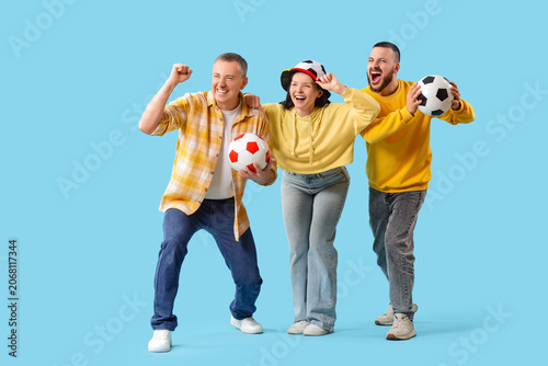 Soccer fans with balls on b...
