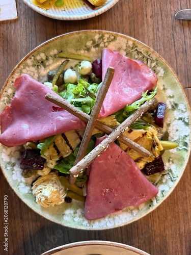 Gourmet Mediterranean salad with smoked beef ham, grilled artichoke hearts and beetroot.