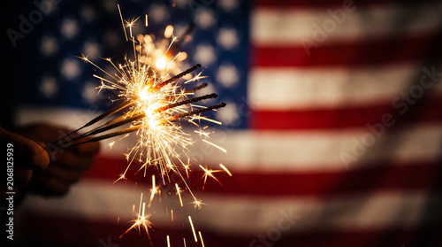 Bright sparklers held against a blurred background representing national celebration and festivity