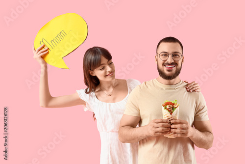 Young couple with tasty san...