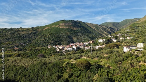 Aerial view of Gragnano near Naples, Italy featuring a hillside village, terraced olive groves and Mediterranean mountain landscape