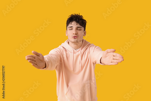 Handsome young man blowing ...