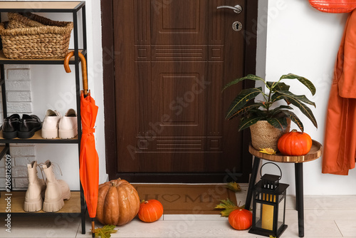 Wooden door with mat, pumpk...