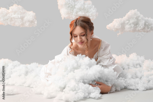 Young woman with white clou...