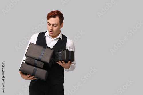 Young man with gift boxes o...
