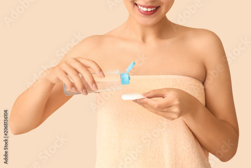 Young woman with bottle of ...