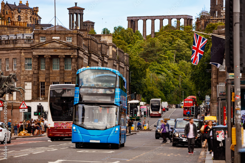 Fototapeta premium Blue double decker bus on busy Edinburgh street scene, Scotland