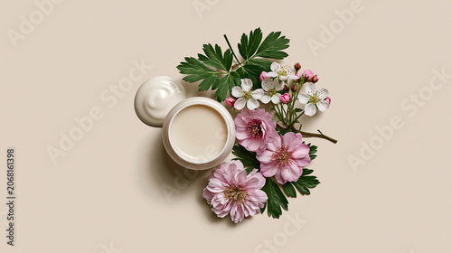 Arrangement of cream jar and flowers on a light background during daytime