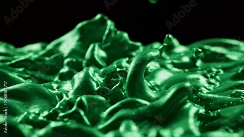 Green Metallic Liquid Splashing and Vibrating in Macro Slow Motion, Isolated on Black Background