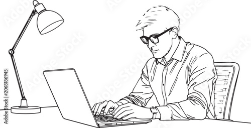 Man sitting at desk working on laptop with lamp beside him