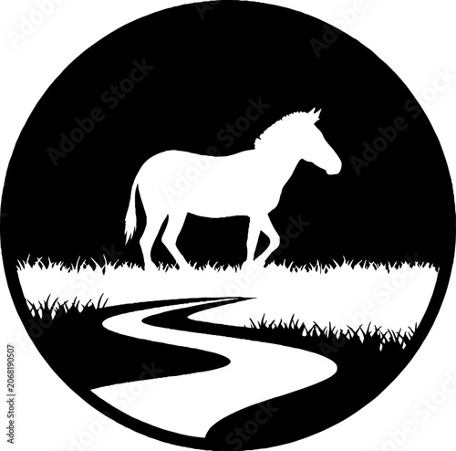 Silhouette of a horse standing by a winding river.