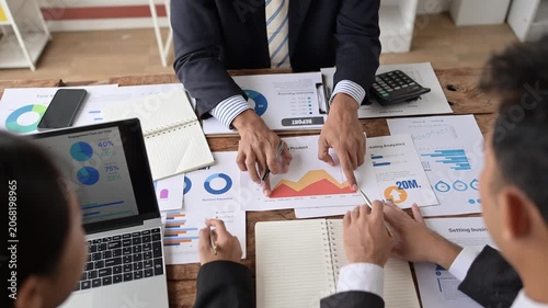 Business people analyzing business growth chart and discussing company strategy