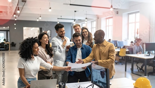 Diverse team collaborating on blueprints in a modern office setting