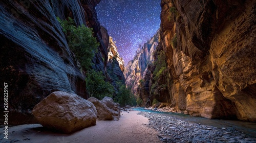 A river flows through a narrow canyon under a starry night sky