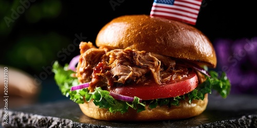 Hearty pulled pork sandwich on a bun, topped with lettuce, tomato, onion, and flag