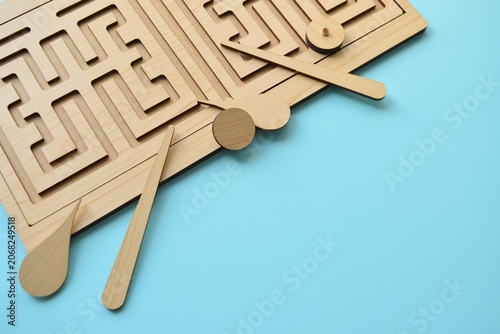 A game for developing logical thinking and brainstorming skills. Close-up of maze puzzle pieces on blue background