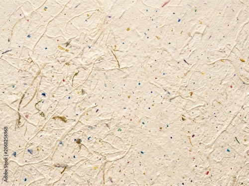 Cream paper with multi-colored flecks texture.