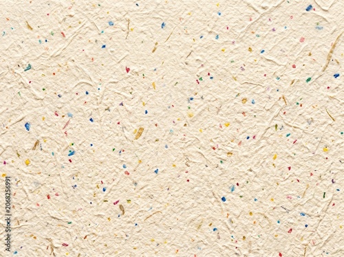 Multicolor confetti flecked textured paper.