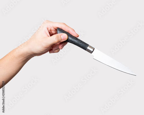Male hand holding a steel cooking knife isolated on white background.