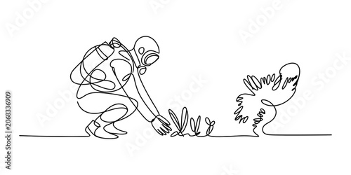 Fotografie One continuous line drawing of an astronaut kneeling down and touching a small p