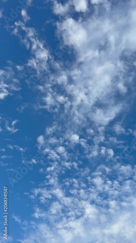 Beautiful blue sky with clouds vertical video.