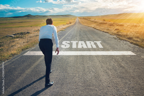 young determined businessman standing in start position