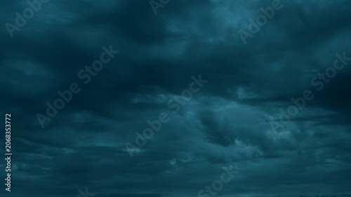 Night storm clouds forming from thick overcast sky before rain.

