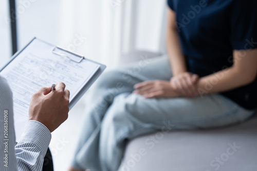 sad female sitting on sofa Patient discussing mental health issues with psychologist. depressed asian woman mental health treatment