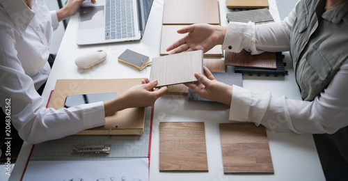 Interior designer presenting eco friendly wooden material samples for sustainable home decor