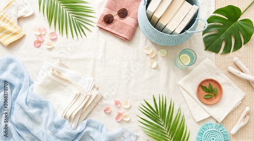 Tropical flat lay arrangement featuring summer accessories and botanicals.