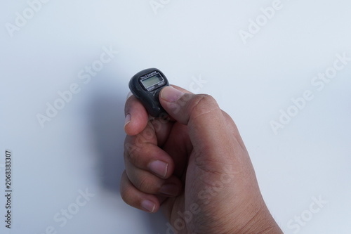 Bild auf Leinwand hand holding digital tally counter isolated on white background