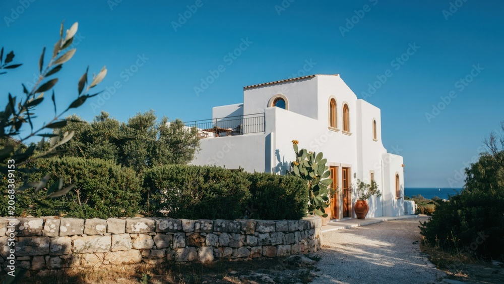 Fototapeta premium White mediterranean villa with stone wall and olive trees