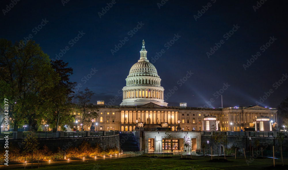 Naklejka premium Washington DC Capitol at twilight. Federal building with columns and flag. Iconic democracy symbol in USA. Night landmark with outdoor lights.