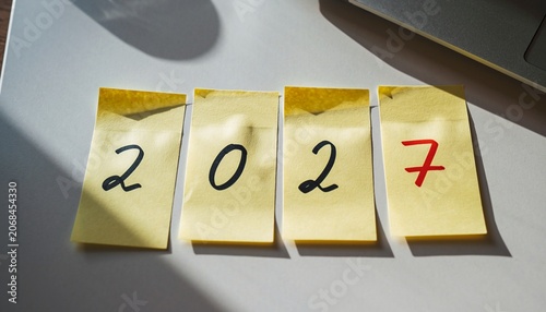 Creative New Year 2027 Concept with Handwritten Numbers on Yellow Sticky Notes.