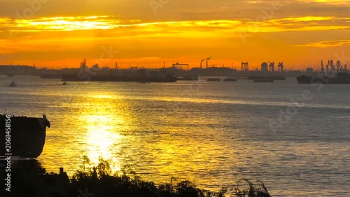 Industrial Harbor and Cargo Ships at Sunset on the River